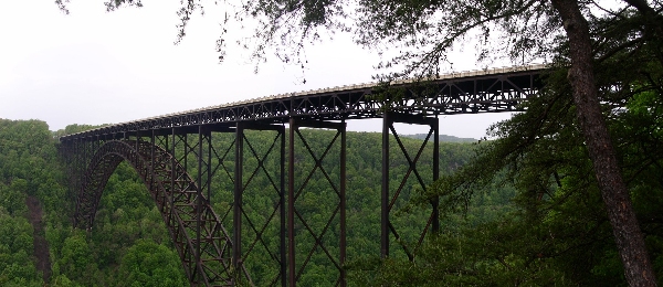 [Two images stitched together to include as much of the bridge as possible. The long bridge is high above the gorge.]